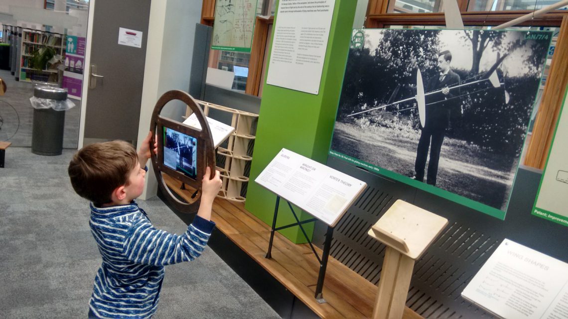 An image of a young boy using an Augmented Reality tablet at the Lanchester Archive.