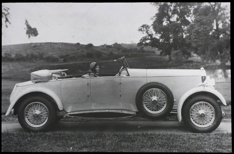 LAN 7/57 - George Lanchester's daughter Nancy in the drivers seat of a 4-door Straight 8 Lanchester with a fantasti aerofoil running board, 1930